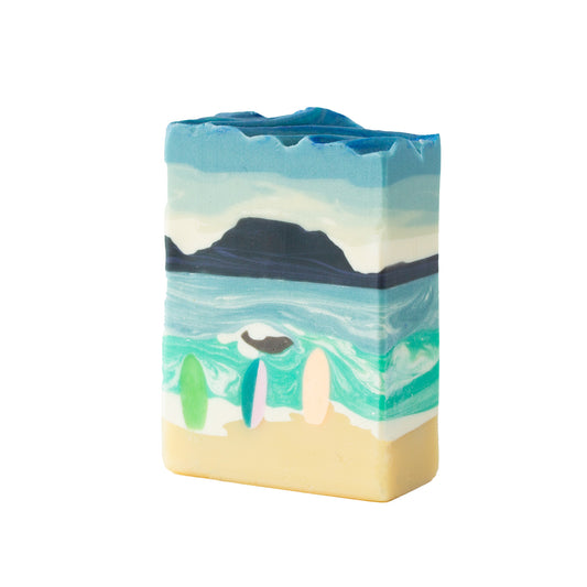 Bar of soap with beach scene and a table mountain design on a white background
