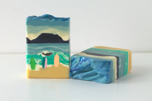 Two bars of soap with artistic designs on a white background