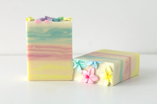 Two bars of tropical soap featuring pastel swirls and colorful flowers