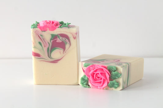 Two bars of soap with pink rose designs on a white background
