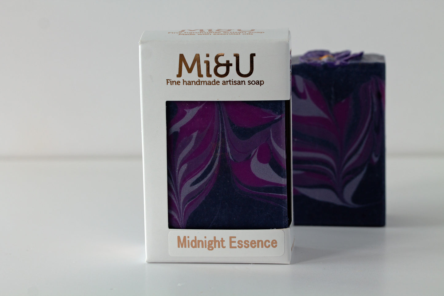Mi&U handmade artisan soap with packaging featuring a purple and black swirled design on a white background.
