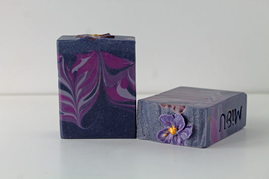 Two bars of soap with decorative designs on a white background