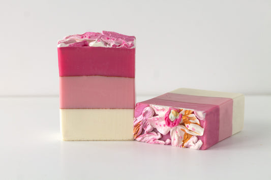 Two layered soap bars with floral top on a white background