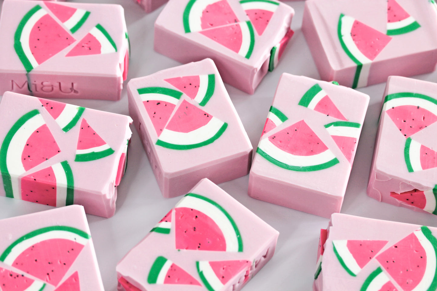 Pink soap bars with watermelon design on a white background
