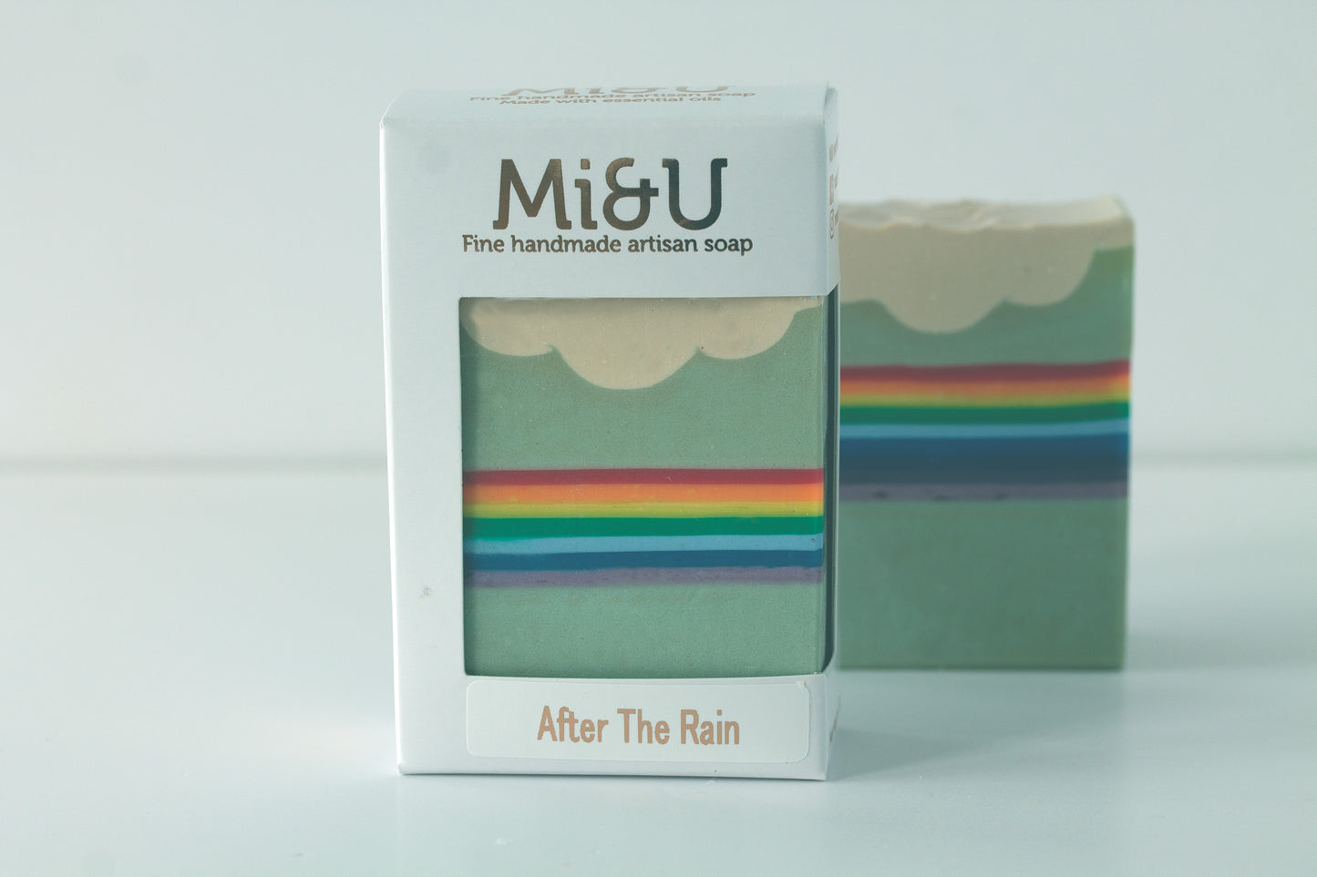 Mi&U soap bar with a rainbow cloud design packaged in a white soap carton.