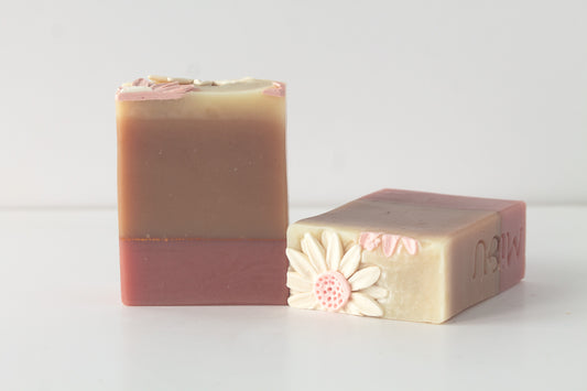 Two bars of soap with floral designs on a light background