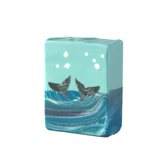 Bar soap with whale tails on a white background