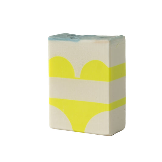 A yellow bikini detail in a soap bar on a white background