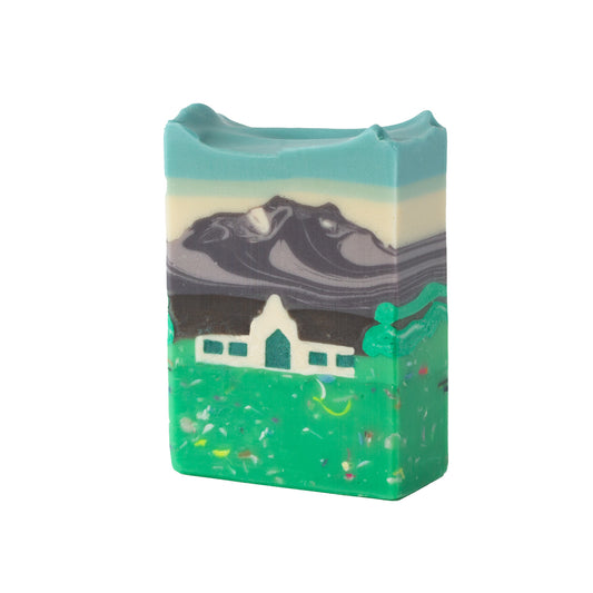 Bar of soap with a mountain and cabin design on a white background