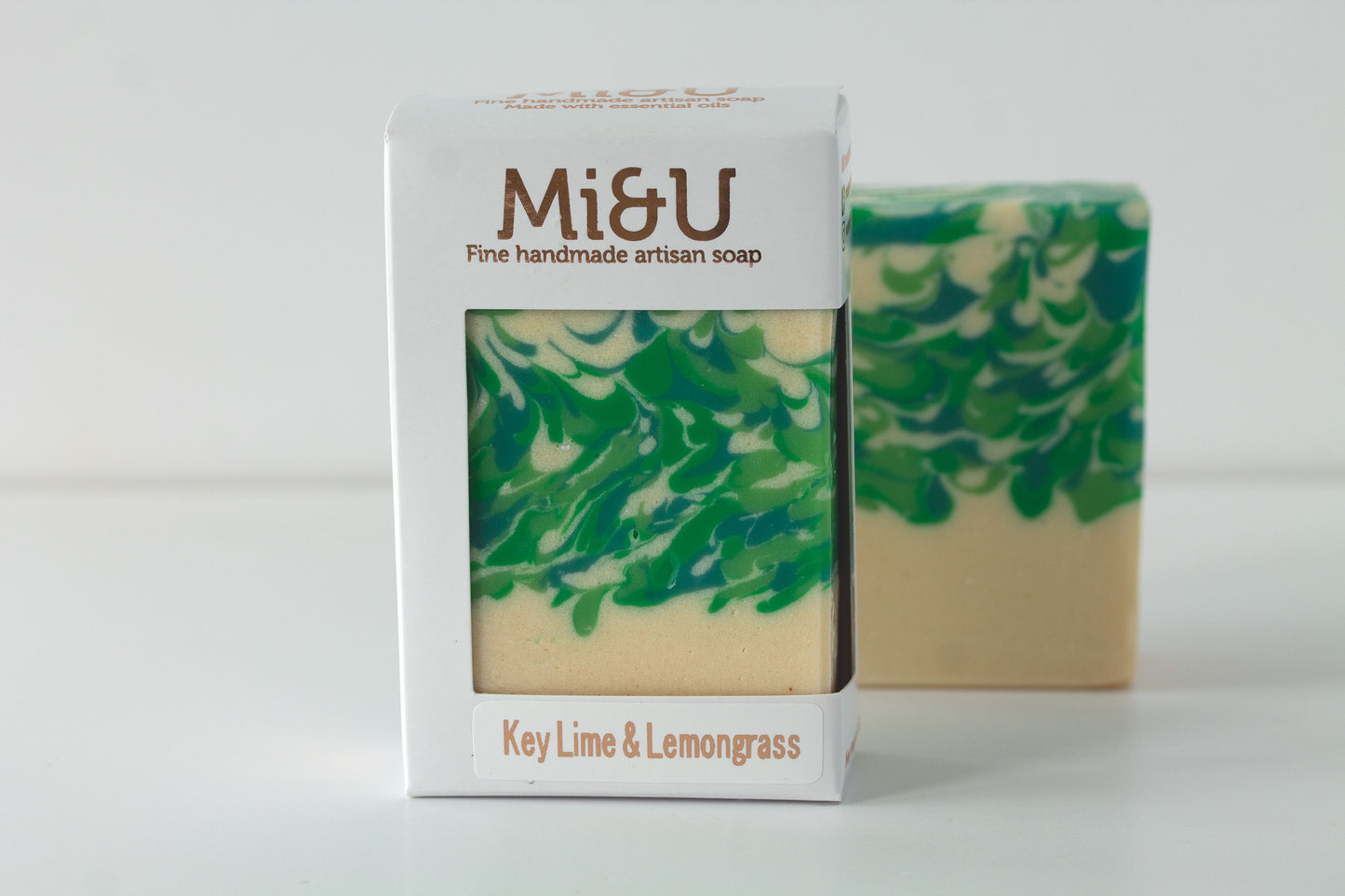 Green and beige soap with packaging labeled 'Mi&U Key Lime & Lemongrass' on a white background