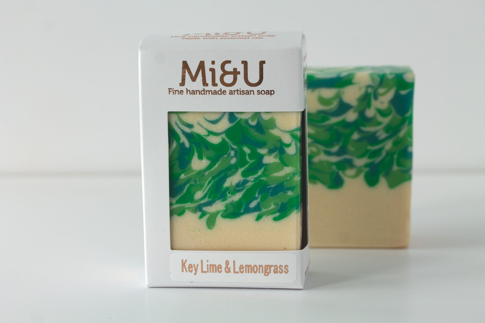 Green and beige soap with packaging labeled 'Mi&U Key Lime & Lemongrass' on a white background