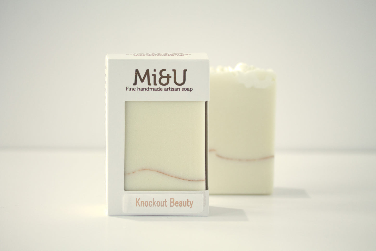 Bar of soap with packaging labeled 'Mi&U Knockout Beauty' on a white background