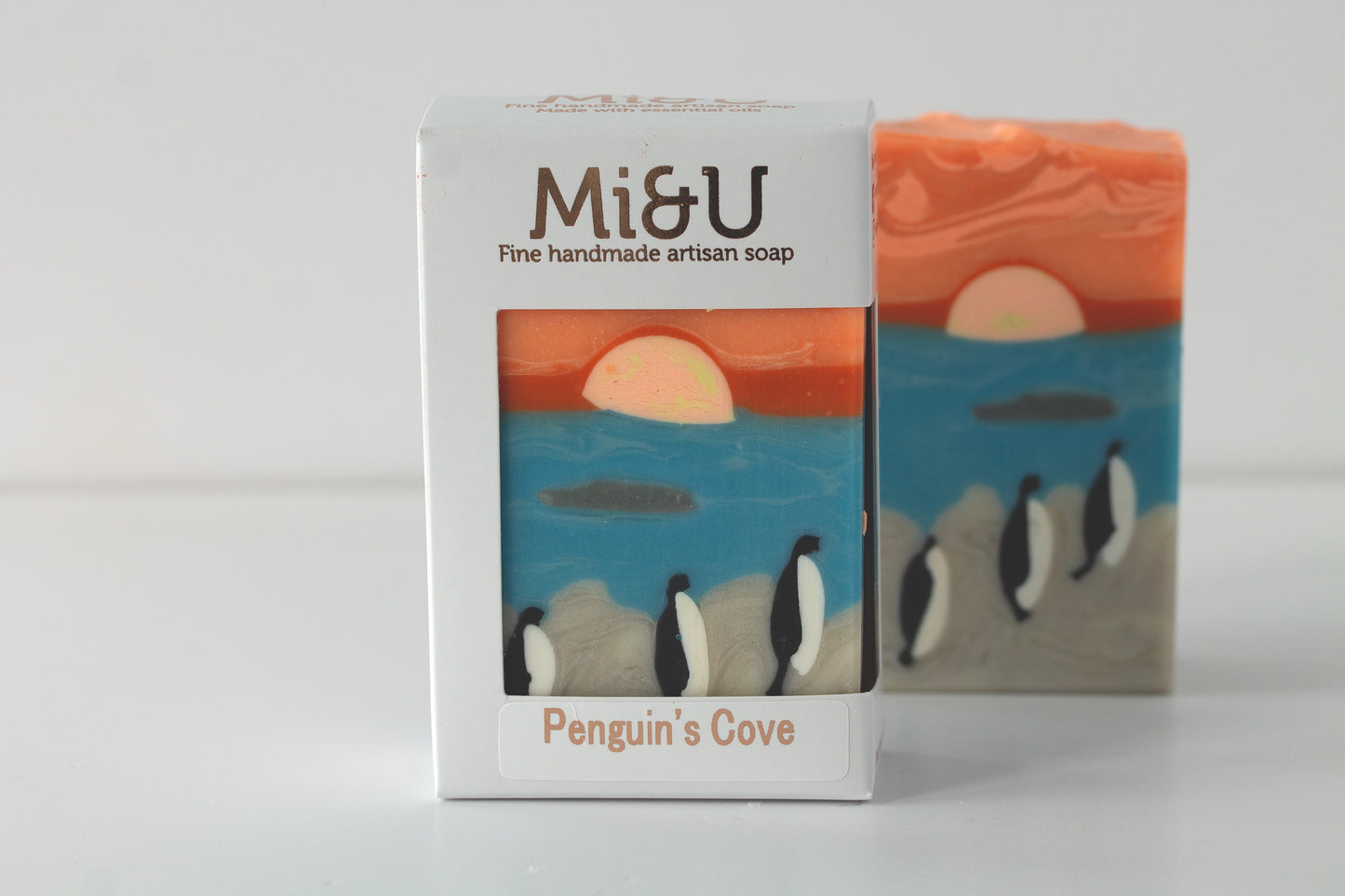 Mi&U soap packaging with penguins and sunset design on a white background