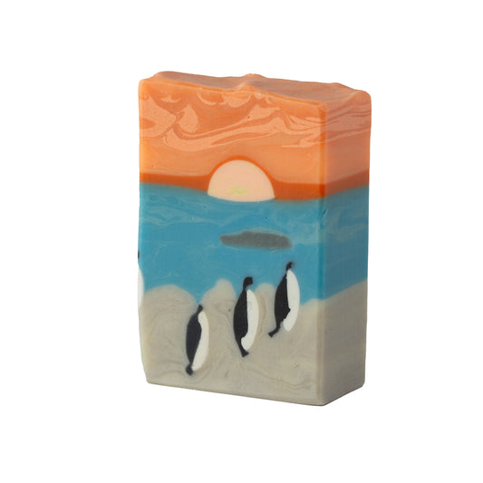 Bar of soap with a sunset and penguins design on a white background