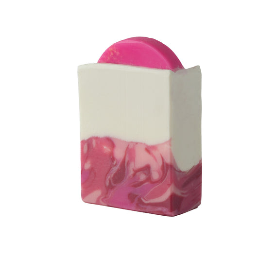 Pomagranate soap with embedded loofah bar on a white background