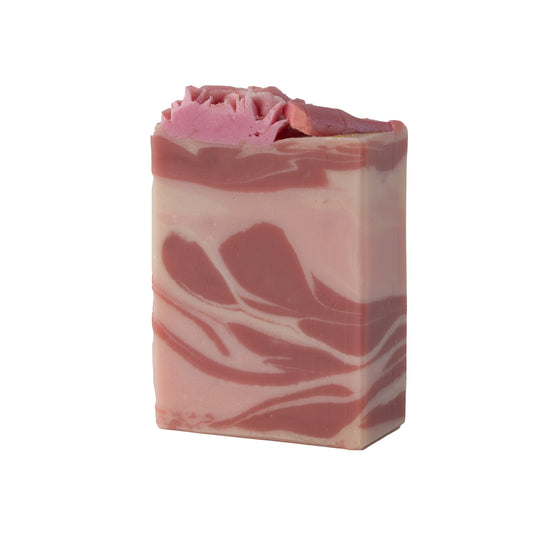 Bar of soap with pink and white swirled pattern on a white background