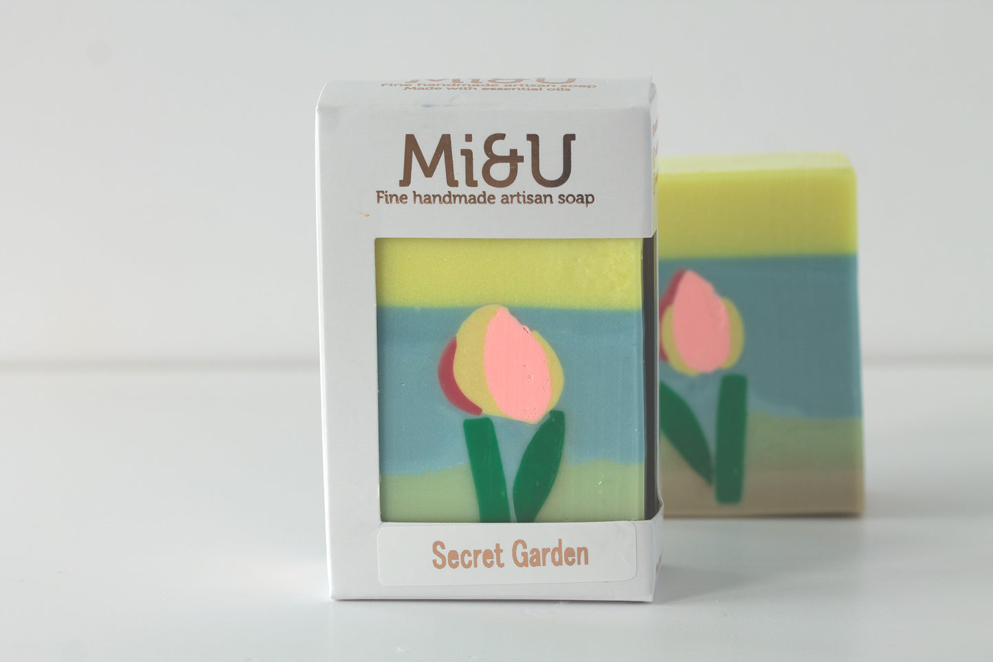 Mié & U soap bar with packaging featuring tulip design on a white background