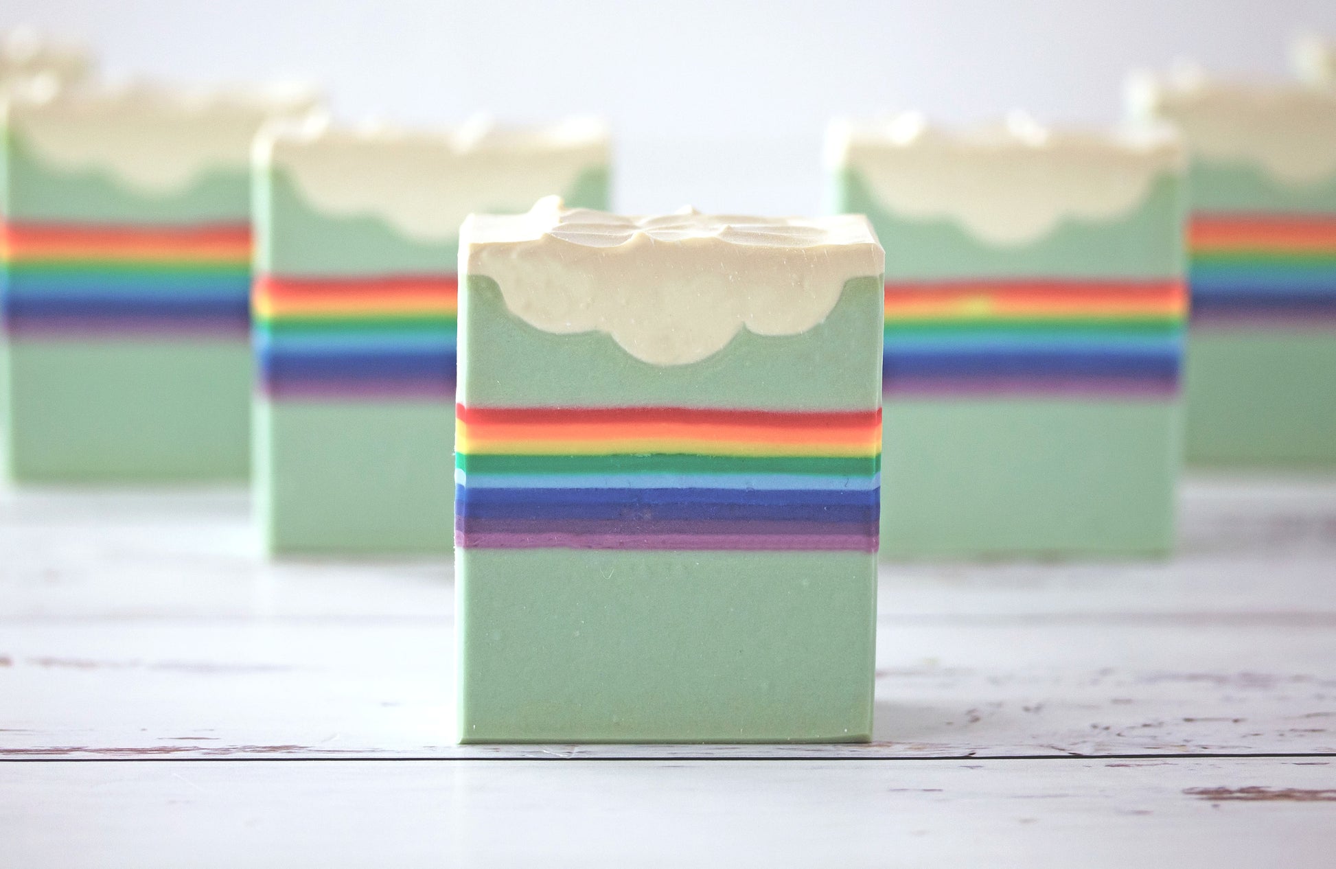 Rainbow soaps on a wooden surface
