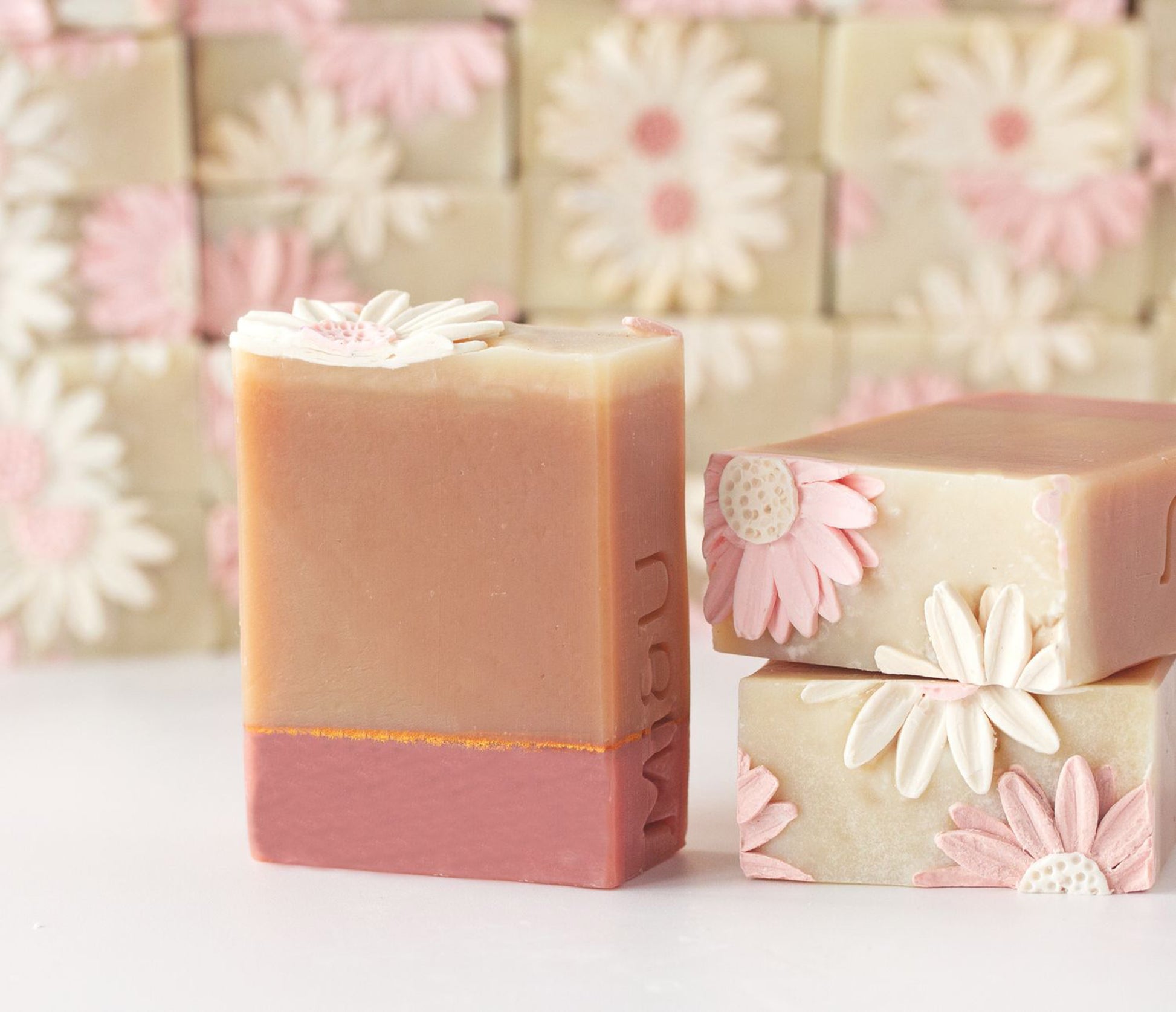 Handmade soap bars with hand piped flowers in the background