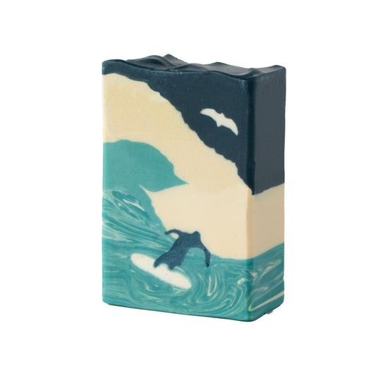 Bar of soap with a surfing wave design on a white background